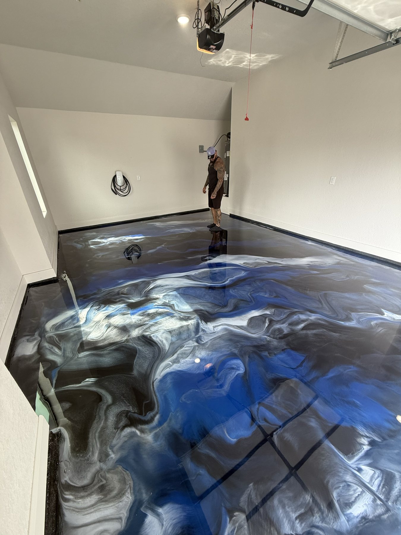 Wide view of a blue metallic epoxy garage floor