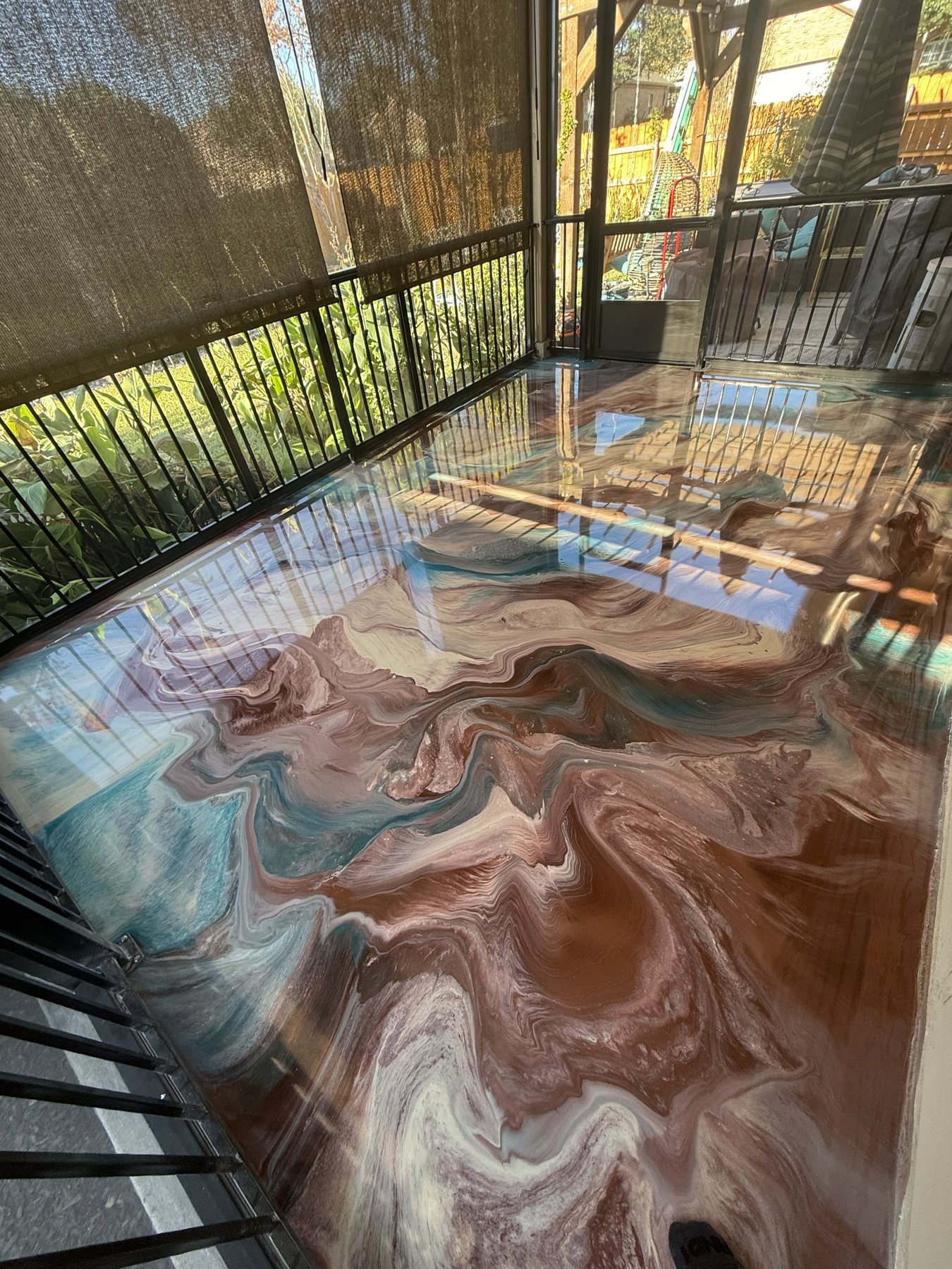 Copper and teal marbled metallic floor on an enclosed porch