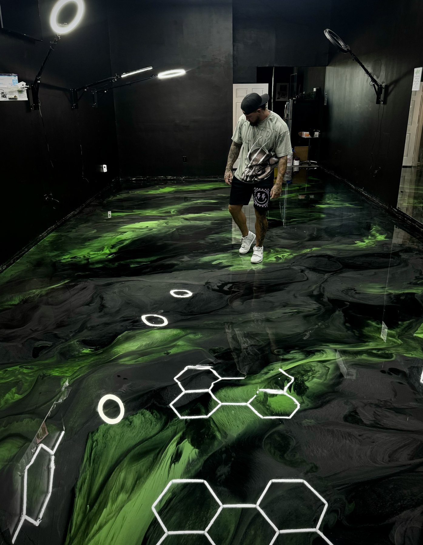 Black and green metallic floor with an inlaid hexagon design